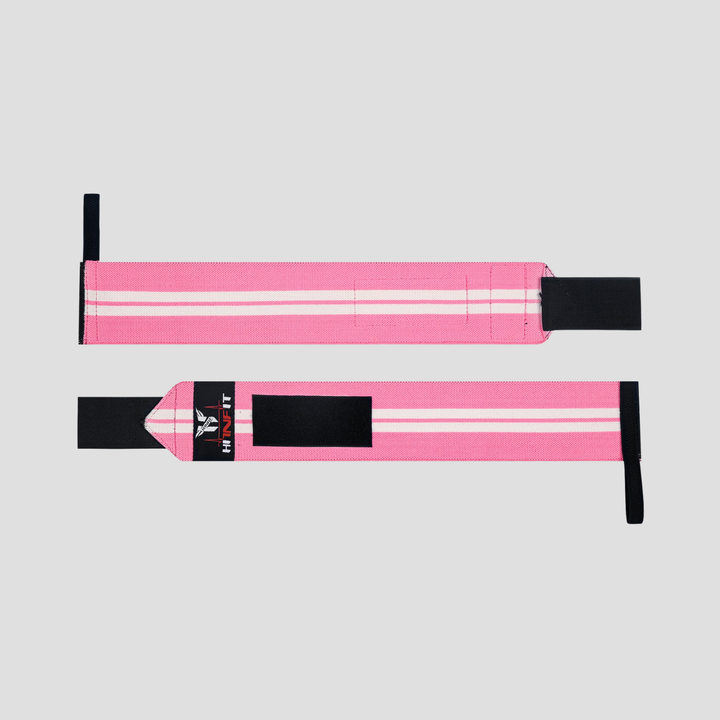 HIT N FIT pink and white weightlifting wrist wraps shown fully extended with thumb loops and black hook-and-loop fastening.